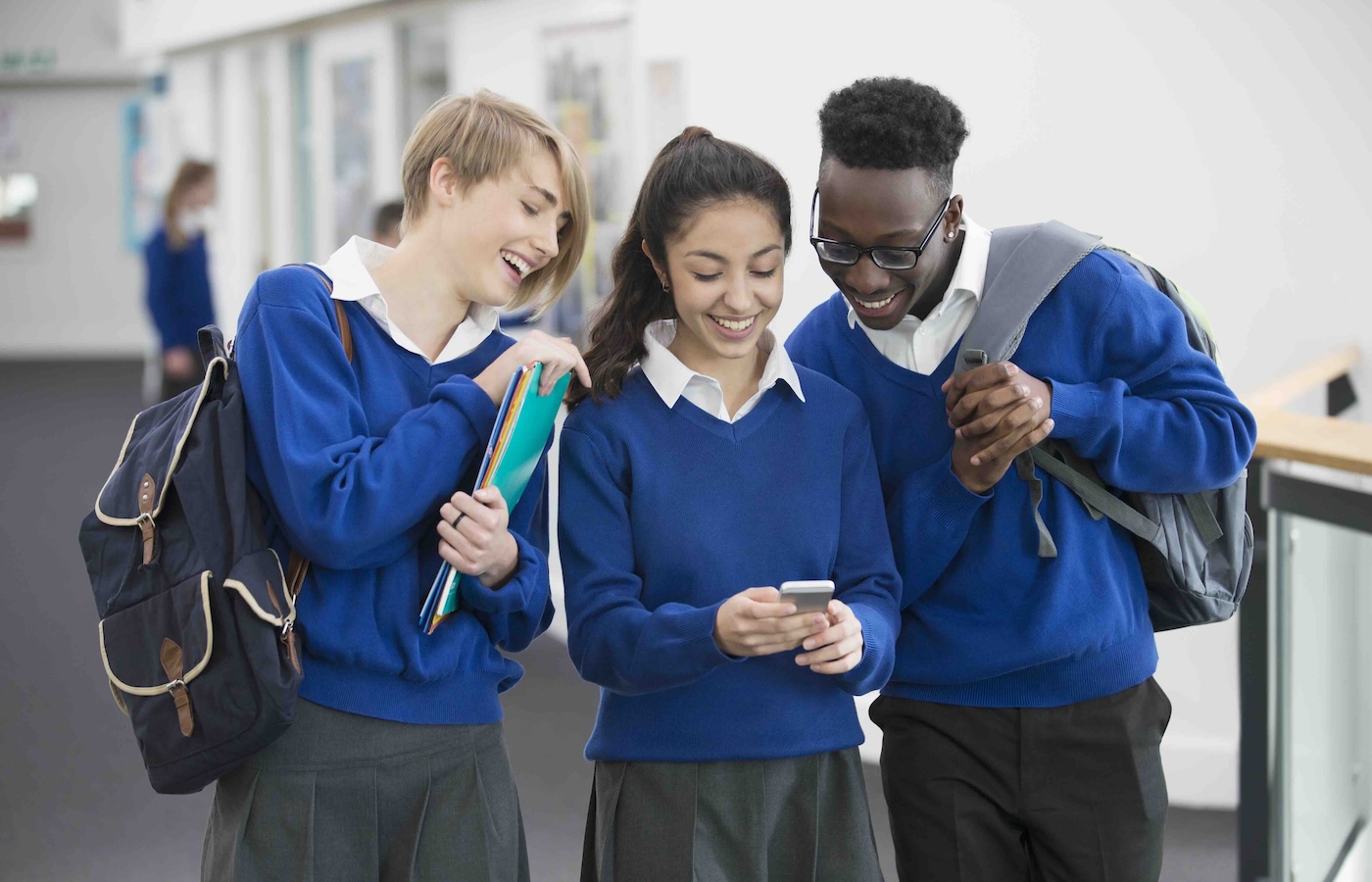 Pupils smiling looking at phone