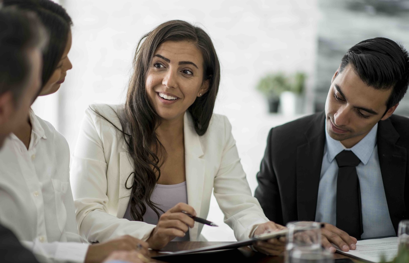 Woman smiling at table with 3 others